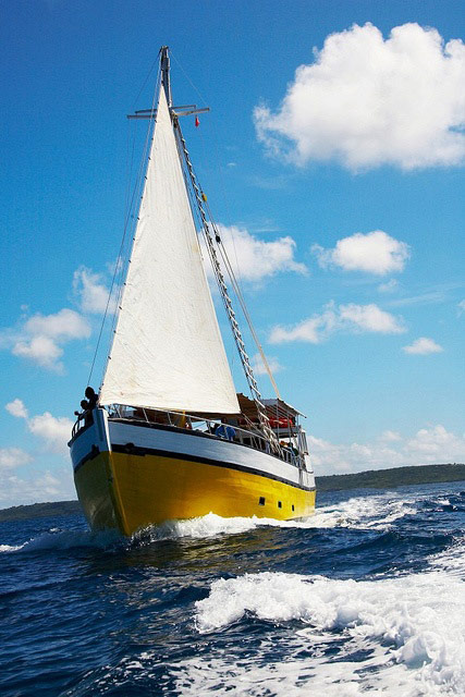 yellow wooden sailboat