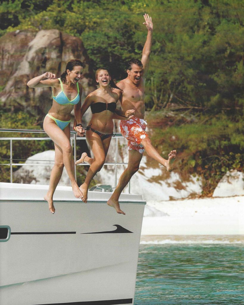 3 people jumping off a boat
